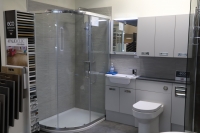 Corner shower with gloss white furniture
